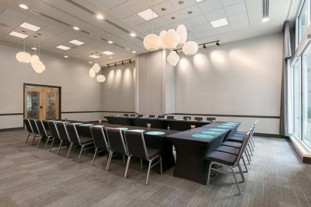 a conference room with a long table and chairs at Aloft Sarasota in Sarasota