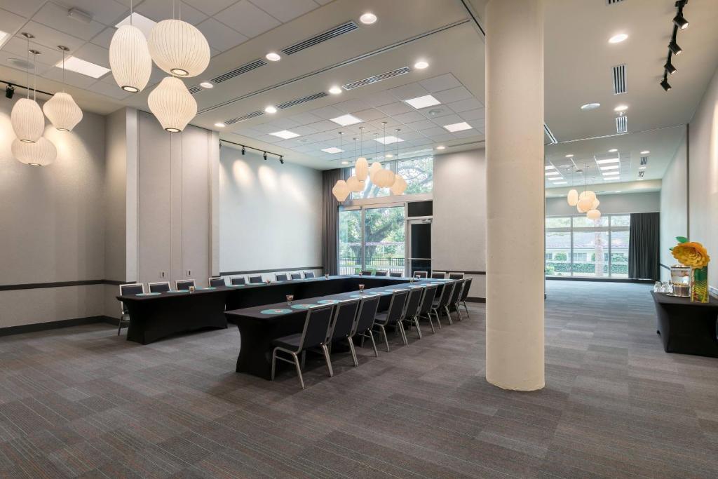 a conference room with tables and chairs and lights at Aloft Sarasota in Sarasota