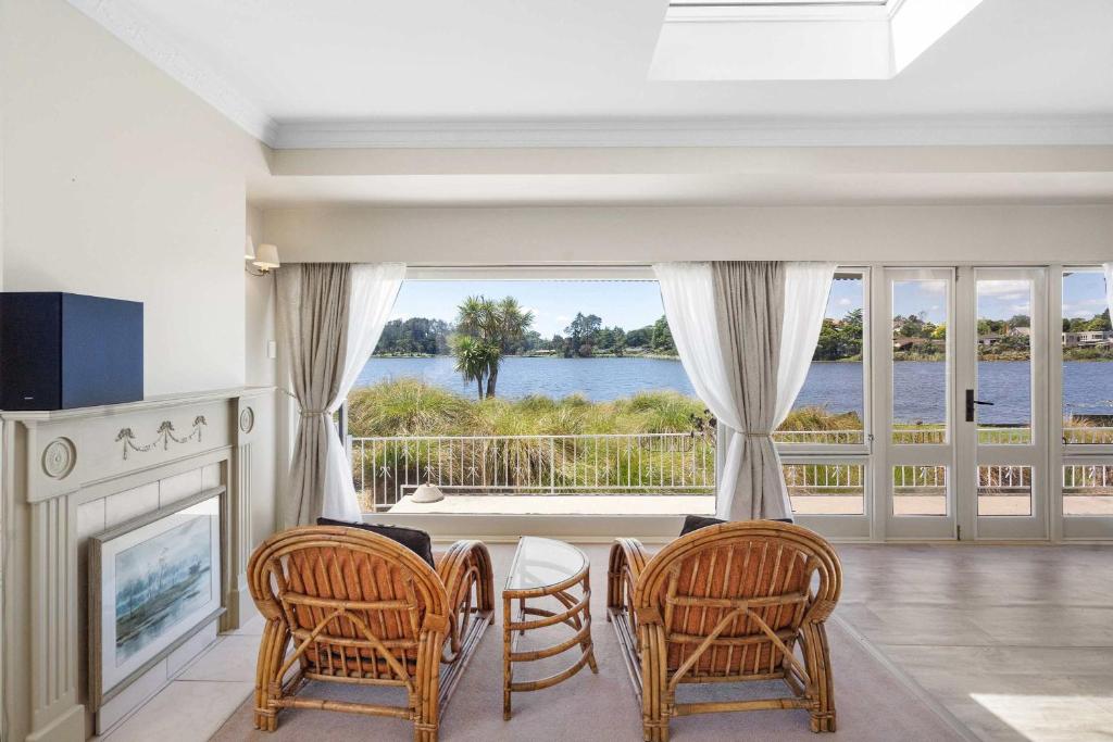 a living room with a fireplace and a view of the water at Stunning Lake Views & Hospital Location in Hamilton