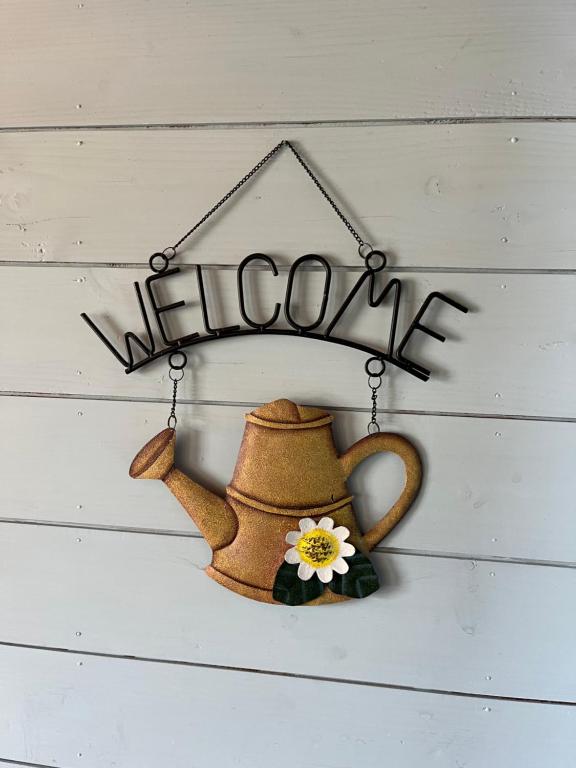 a sign that says welcome and a teapot at Pension Kurumi no Ki in Toyooka