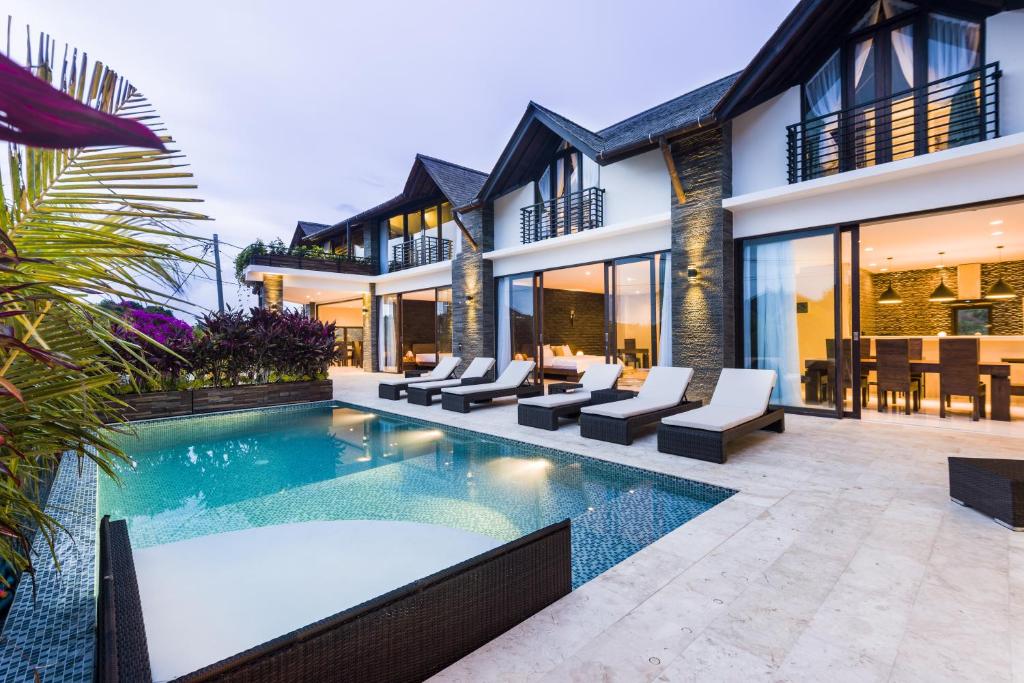 an exterior view of a villa with a swimming pool at 14 Palms in Uluwatu