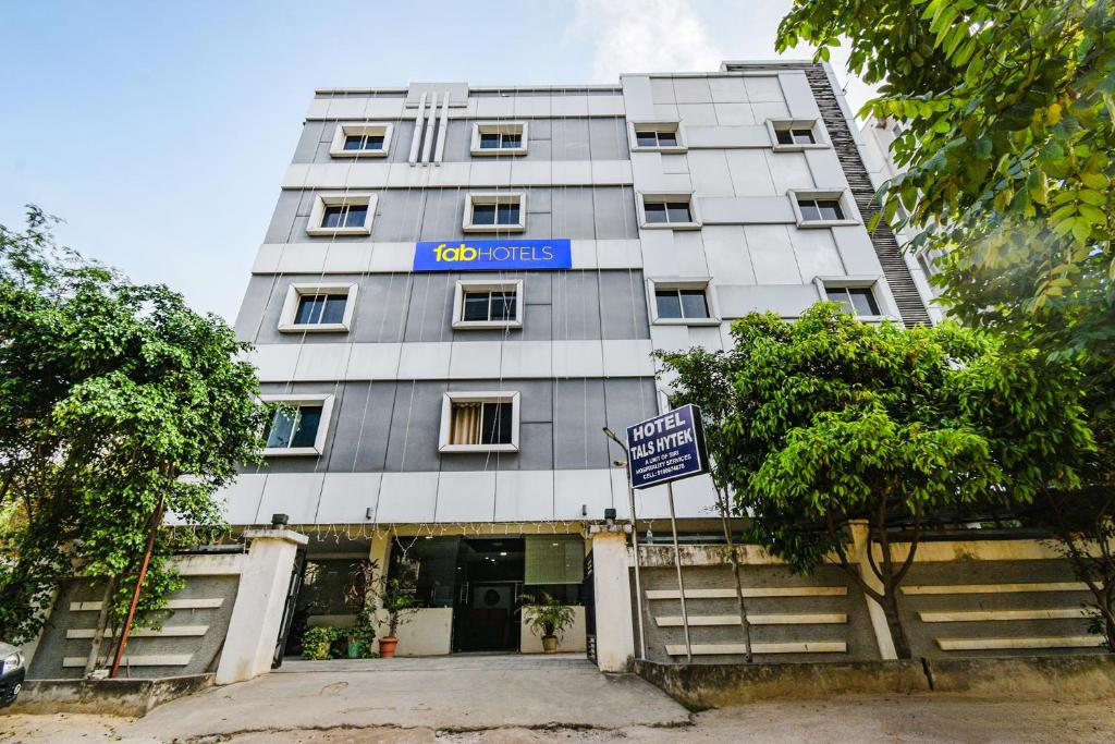 a building with a sign on the front of it at FabHotel Tals Hitech Nr Hitech City in Hyderabad