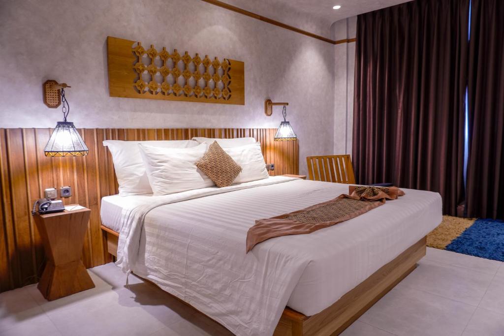 Postel nebo postele na pokoji v ubytování de JAVA Hotel Bandung