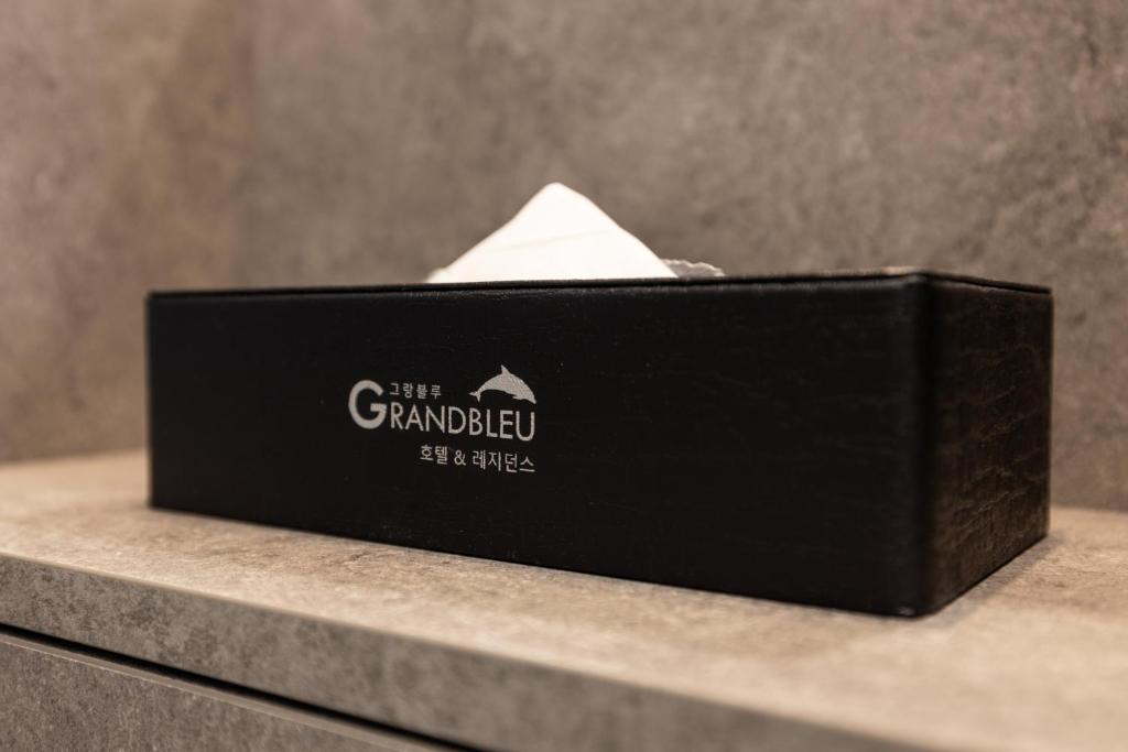 a black card box sitting on top of some stairs at Grand Bleu Hotel & Residence in Incheon