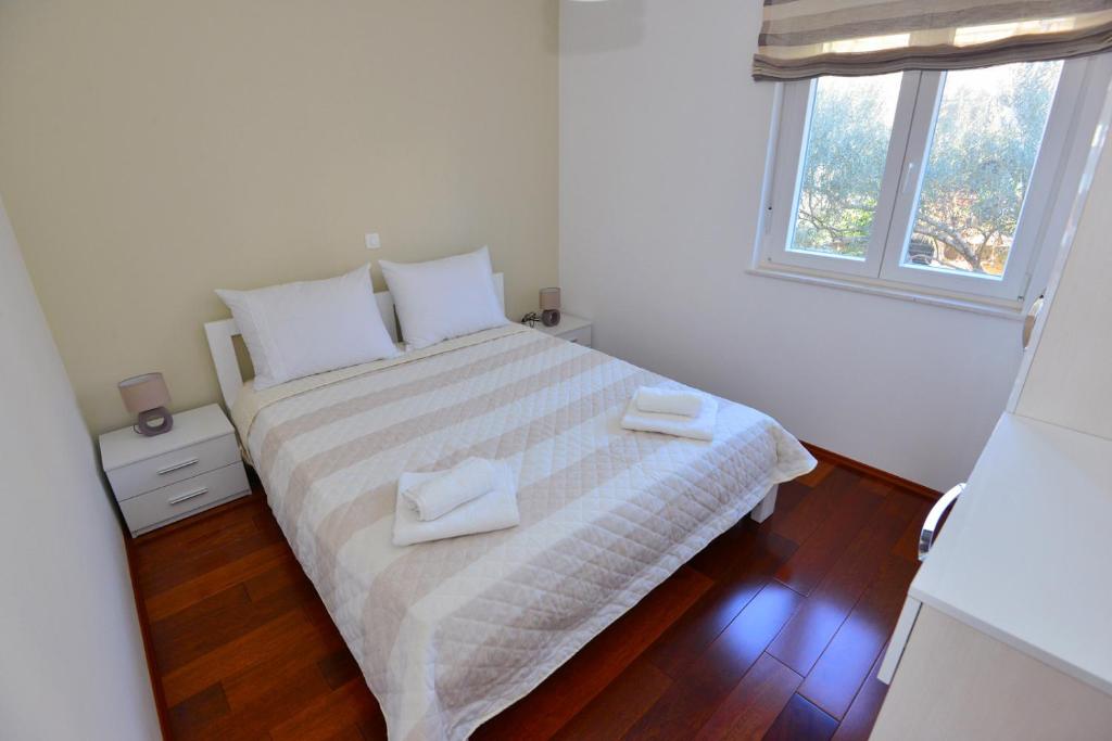 Posteľ alebo postele v izbe v ubytovaní Apartments Villa Coratina