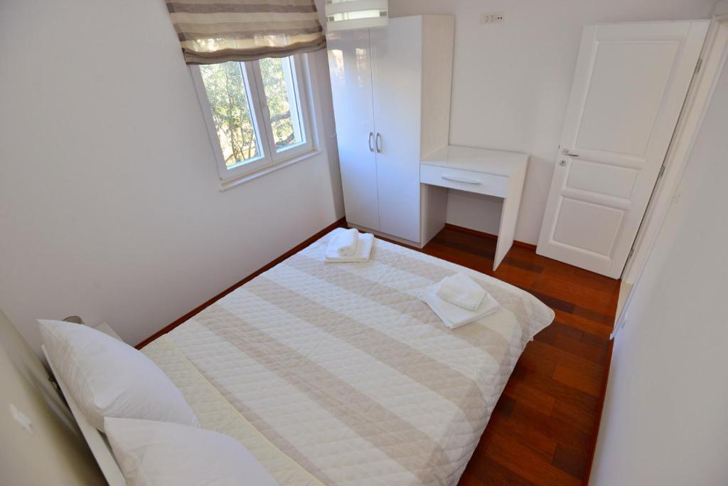 Posteľ alebo postele v izbe v ubytovaní Apartments Villa Coratina