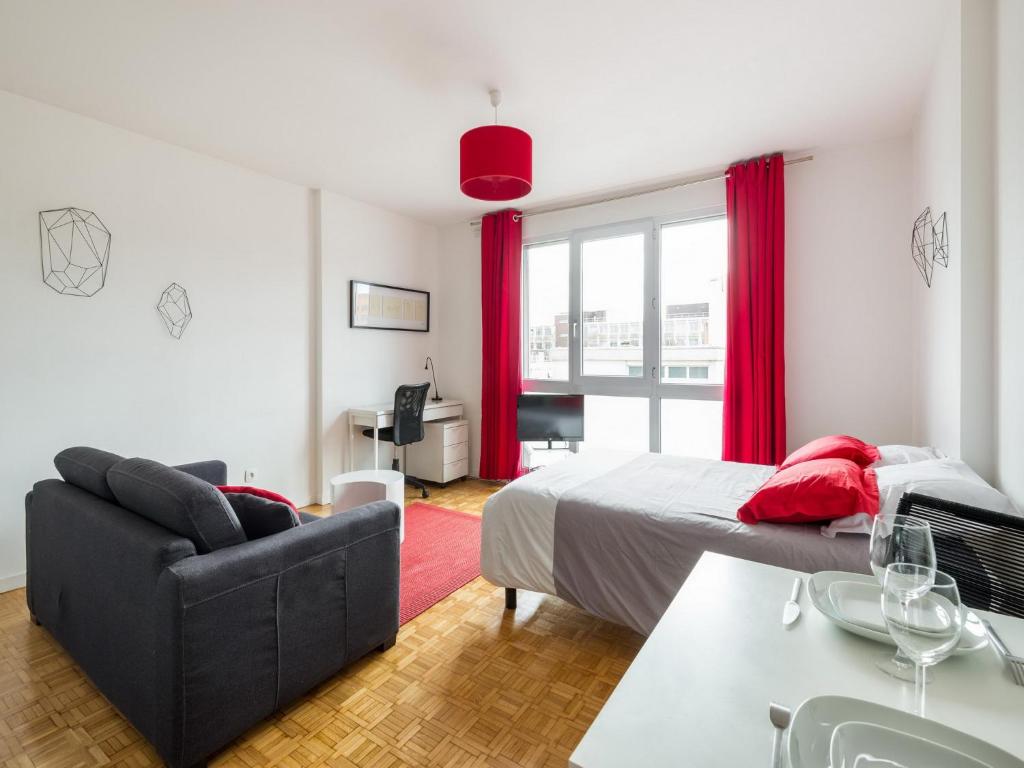 a bedroom with a bed and a couch and a table at Studio Part Dieu in Lyon