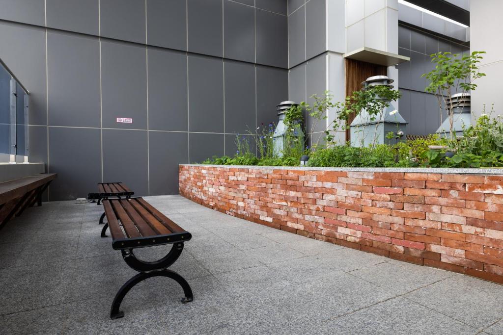 a bench sitting in front of a building at Grand Bleu Hotel & Residence in Incheon