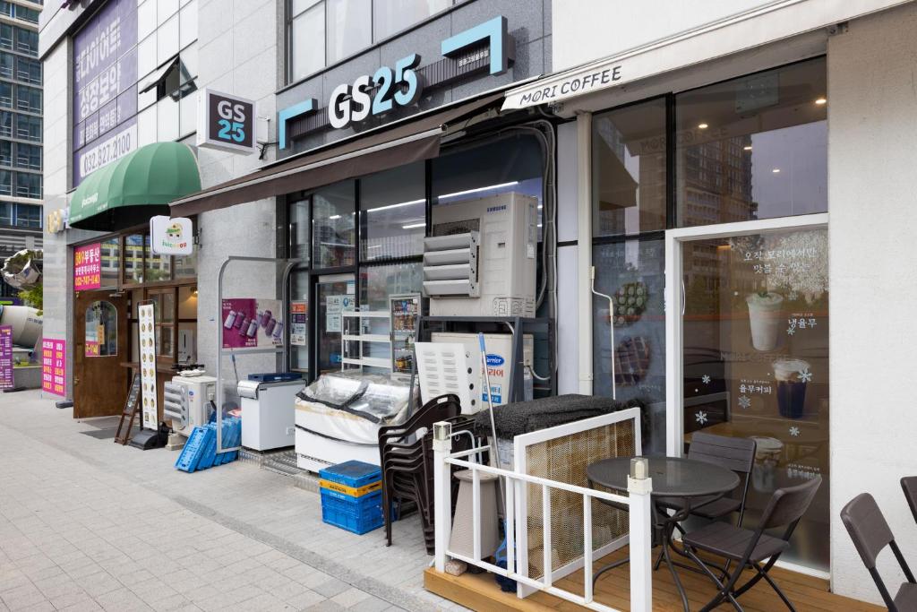 a store front of a store with a table and chairs at Grand Bleu Hotel & Residence in Incheon