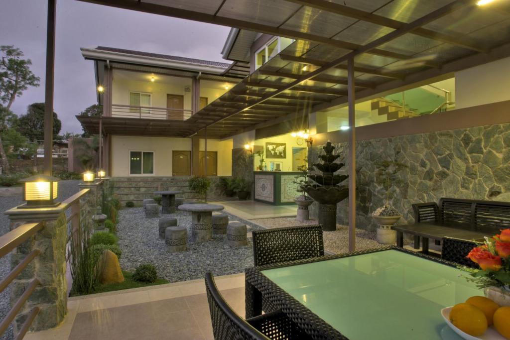 a patio of a house with a table and chairs at Tagaytay Wingate Manor in Tagaytay