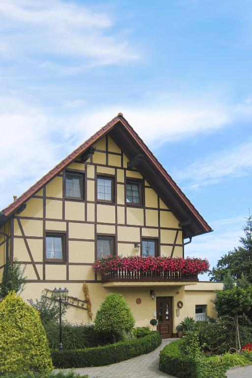 a house with flowers in front of it at Landhotel Biberburg in Bad Liebenwerda