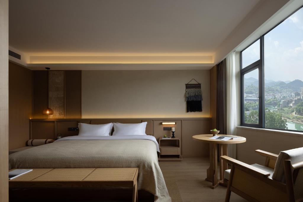 Postel nebo postele na pokoji v ubytování Yanyu Yunxi Resort Hotel 烟雨云兮酒店