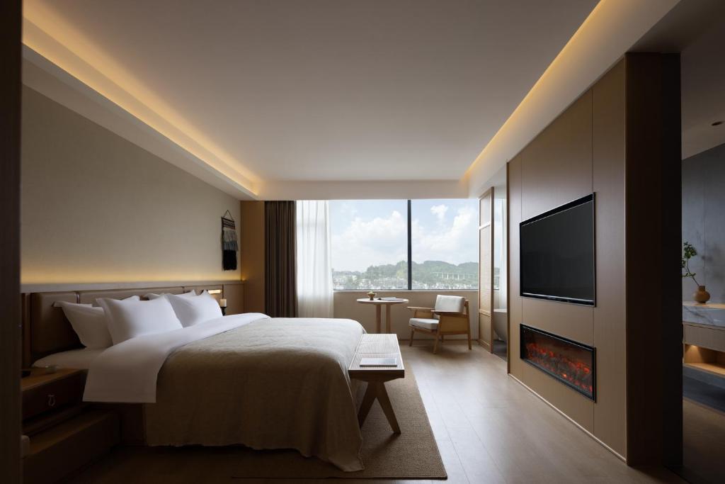 Postel nebo postele na pokoji v ubytování Yanyu Yunxi Resort Hotel 烟雨云兮酒店