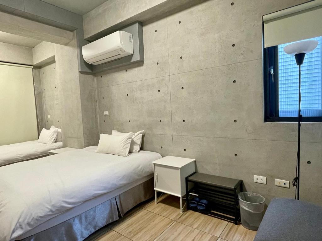Voodi või voodid majutusasutuse Mei Jen Home B&B 民宿 toas