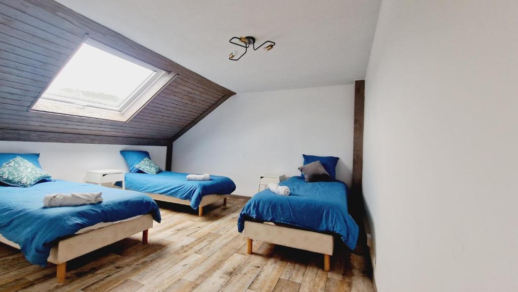 une chambre avec deux lits et une fenêtre dans l'établissement F3 Duplex Fresse, à Fresse-sur-Moselle