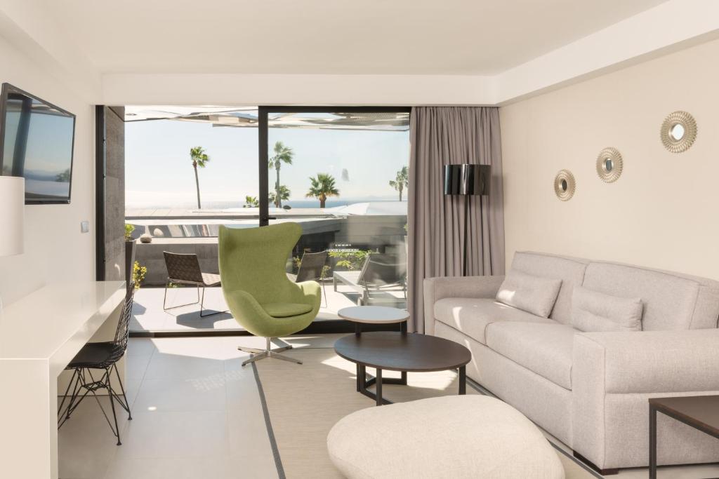 a living room with a couch and a table at La Isla y el Mar, Hotel Boutique in Puerto del Carmen