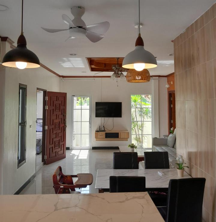 a living room with a table and chairs and a tv at 3BR Villa near Boat Avenue Laguna beach in Bang Tao Beach