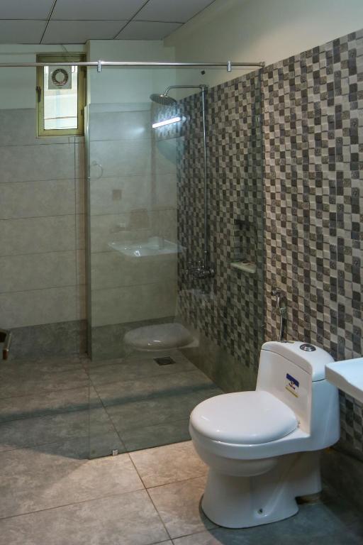 カラチにあるHotel Pearl Innのバスルーム(トイレ、シャワー付)
