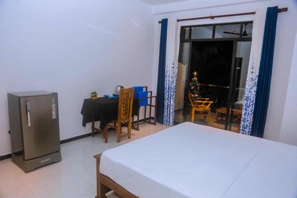 a room with a table and a dining room at Mirissa Breeze in Mirissa
