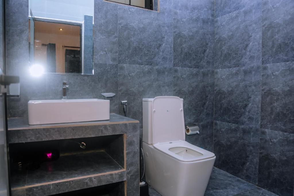 a bathroom with a white toilet and a sink at Mirissa Breeze in Mirissa