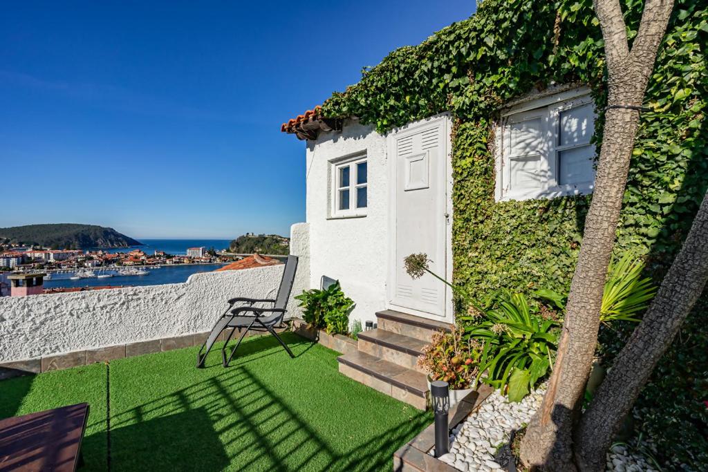 a house with green ivy on the side of it at La terraza de ribadesella in Ribadesella