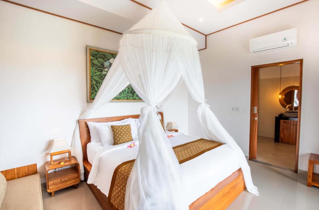 Postel nebo postele na pokoji v ubytování Weda Villas