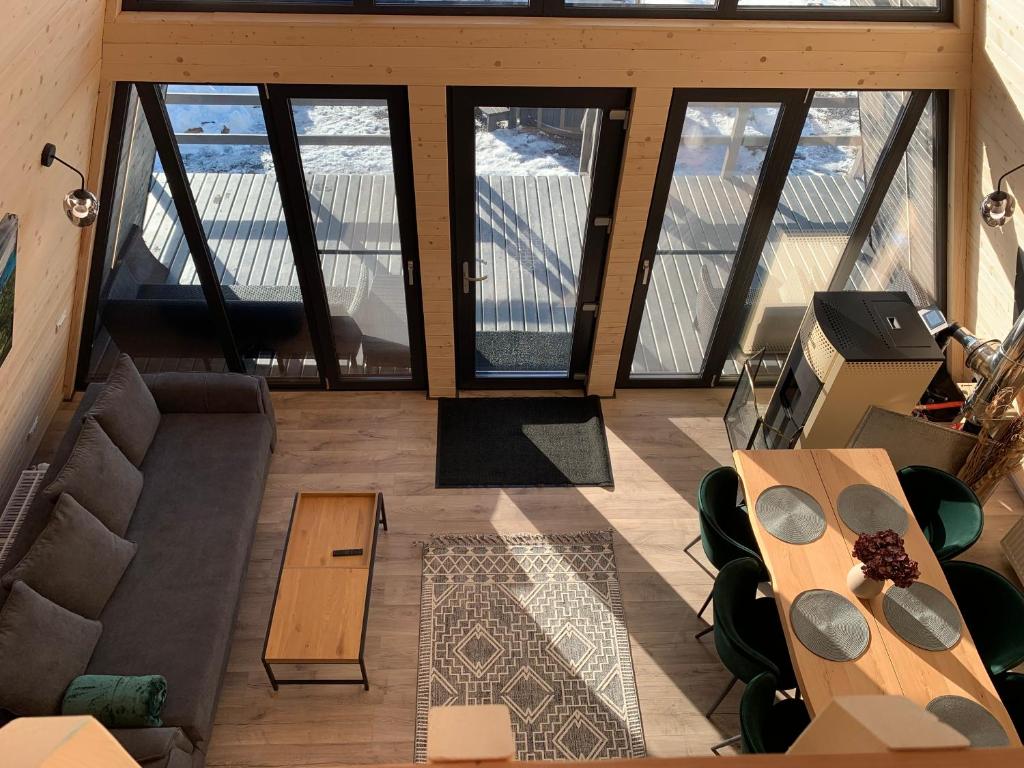 a living room with views of the brooklyn bridge at Chalet Charme Bucovina in Coşna