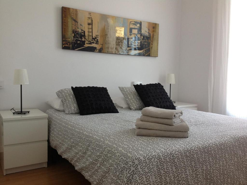 a bedroom with a bed with towels on it at Lets Holidays Apartment Barcelona near beach in Barcelona