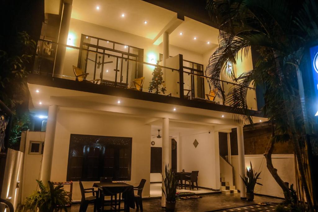 a view of a house at night with a balcony at Mirissa Breeze in Mirissa