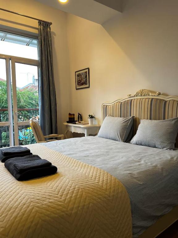 a bedroom with a bed with two towels on it at Christine's Apartment in Sofia