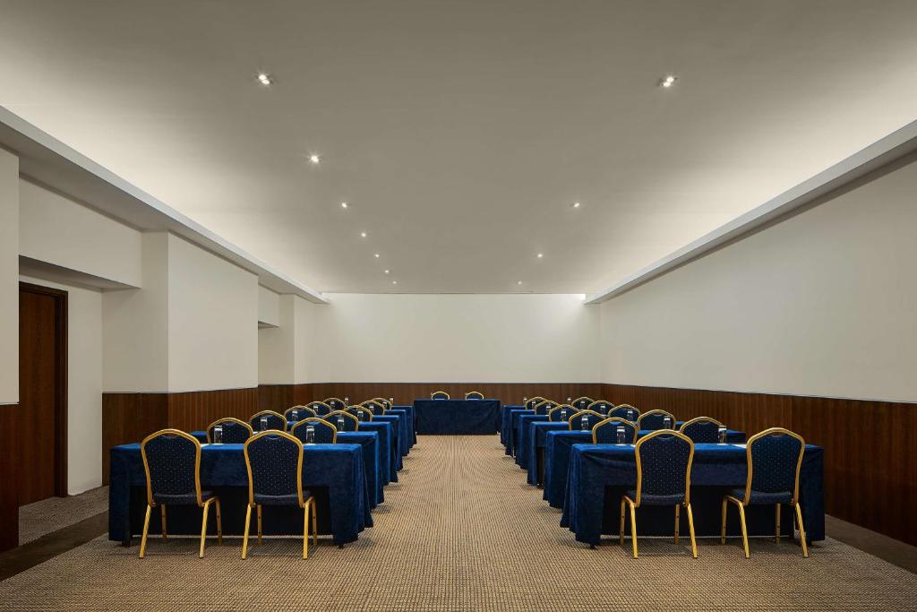 a conference room with blue tables and chairs at Tivoli Marina Vilamoura in Vilamoura