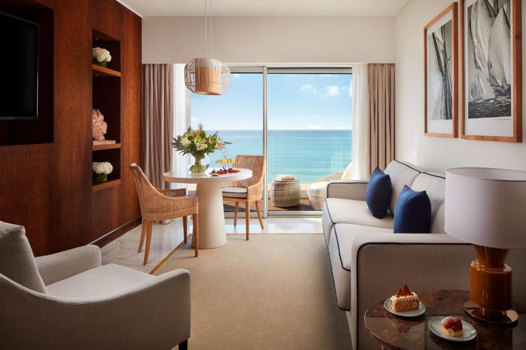 a living room with a view of the ocean at Tivoli Marina Vilamoura in Vilamoura