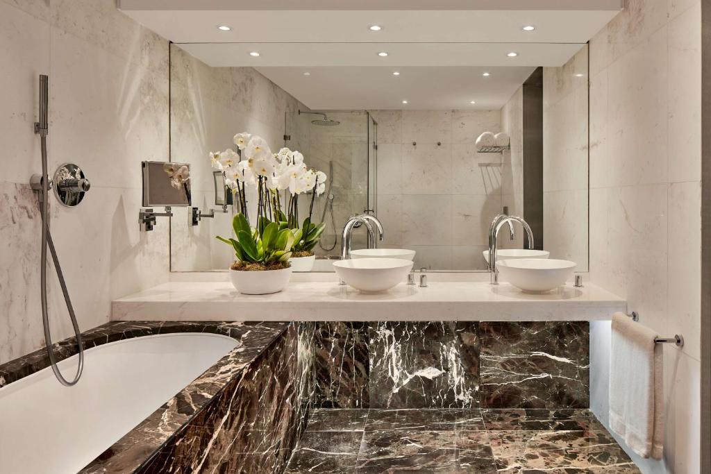 a bathroom with two sinks and a marble counter at Tivoli Marina Vilamoura in Vilamoura