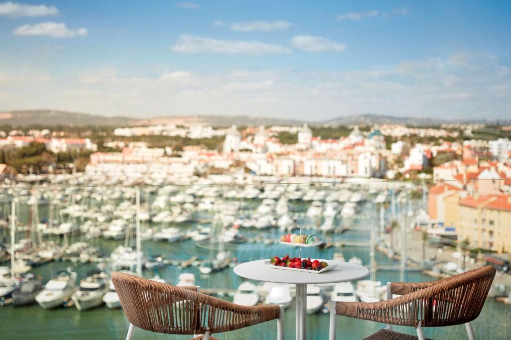 a table with a plate of fruit on top of a marina at Tivoli Marina Vilamoura in Vilamoura