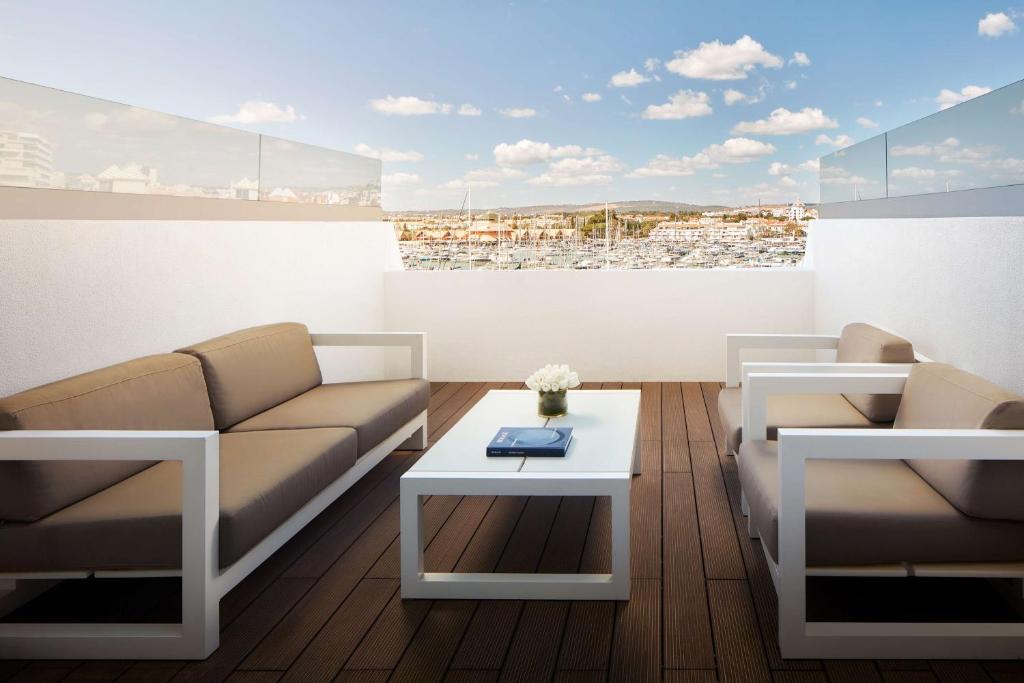 a living room with a couch and a table at Tivoli Marina Vilamoura in Vilamoura