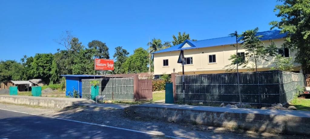 a house on the side of a road with a fence at The Western Lodge in Narjon Basti