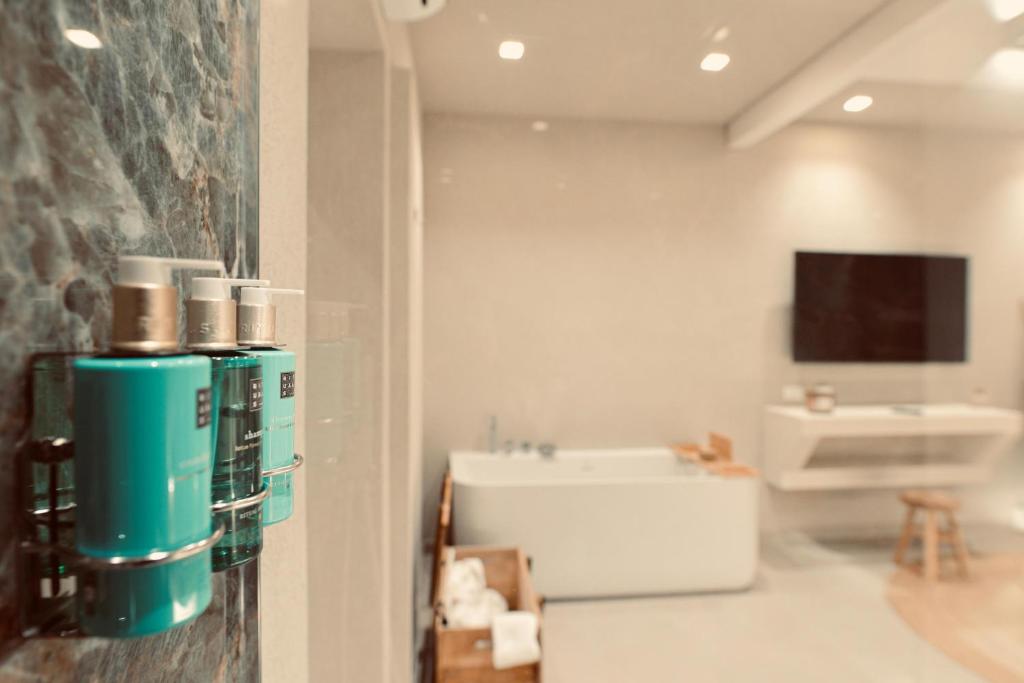 a bathroom with a white tub and a sink at Palermo Inn Boutique Arte in Palermo