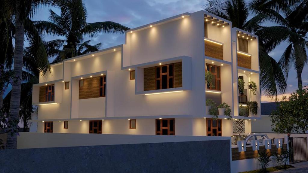 特里凡得琅The MULBERRY Cottage的一座白色的大房子,灯火通明