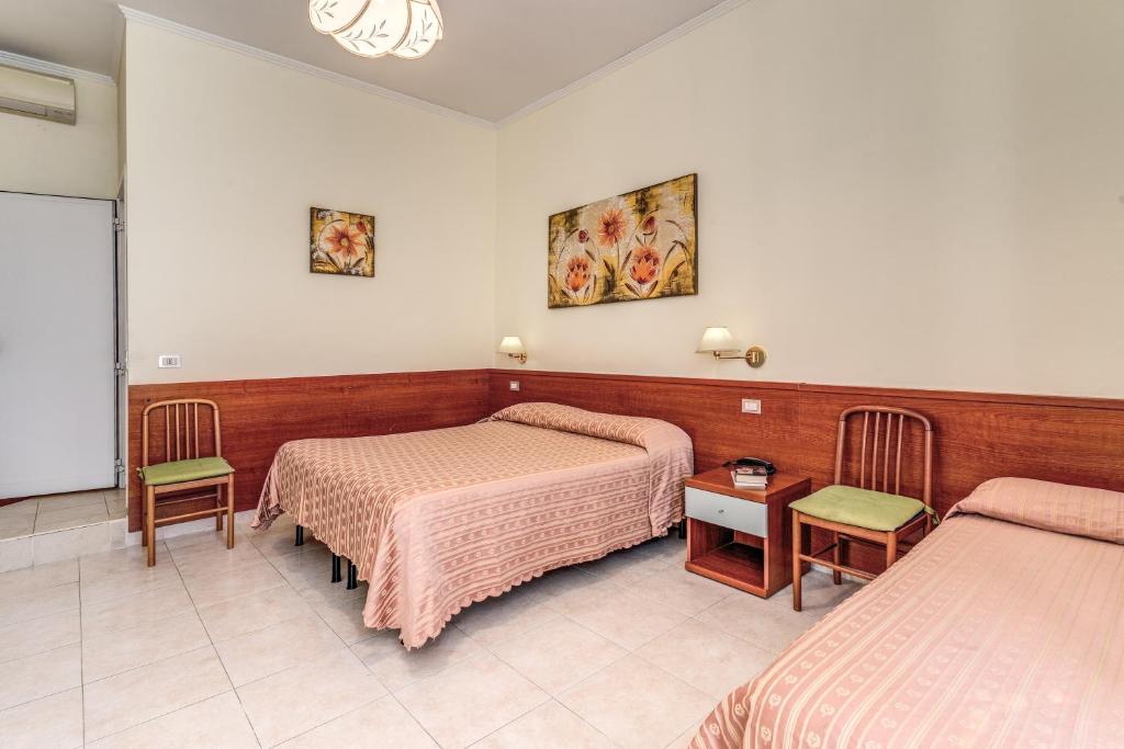 Postel nebo postele na pokoji v ubytování Hotel Katty