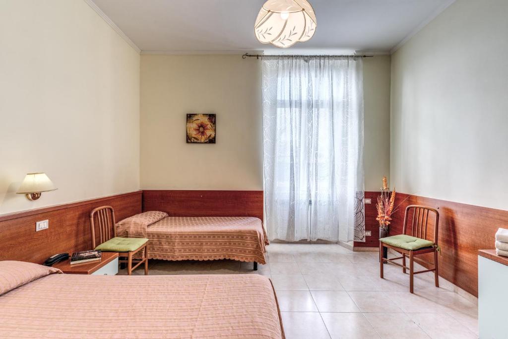 Postel nebo postele na pokoji v ubytování Hotel Katty