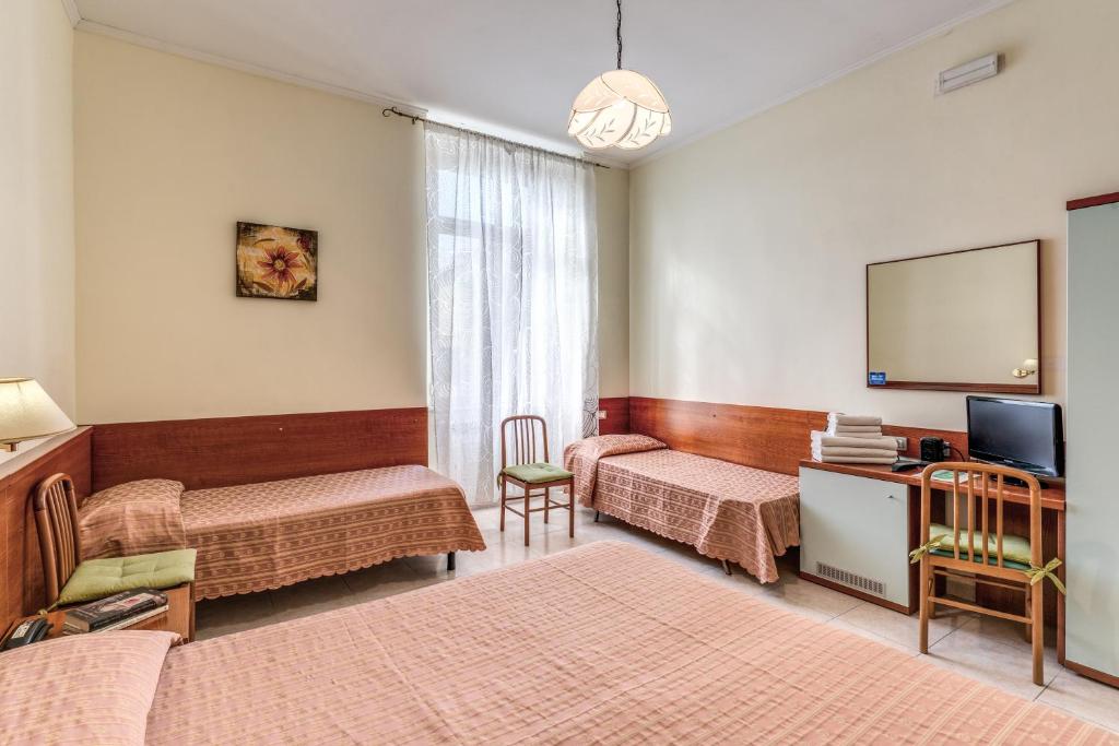 Postel nebo postele na pokoji v ubytování Hotel Katty