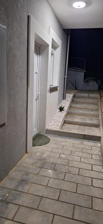 an empty hallway with a white door and stairs at Stan Banja Luka Paprikovac in Banja Luka