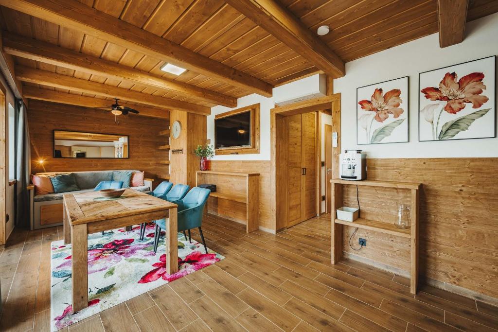 a living room with a table and a couch at Rezidence KUPEC in Frymburk