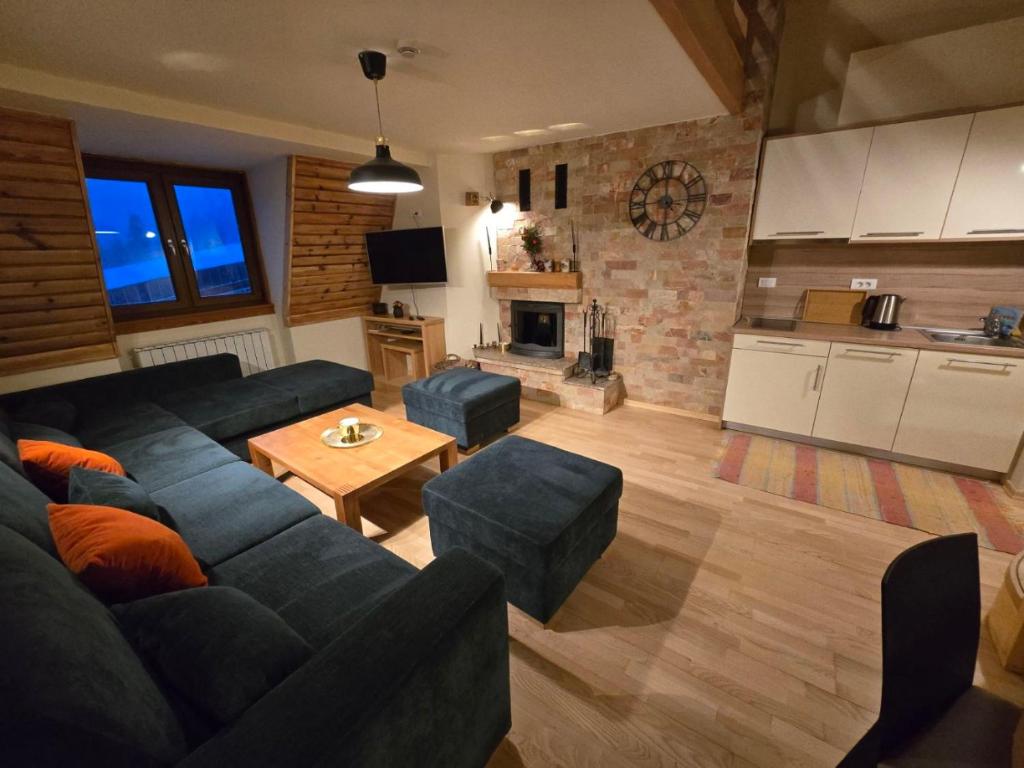 a living room with a couch and a table at Apartman 304 - Aparthotel Vucko in Jahorina