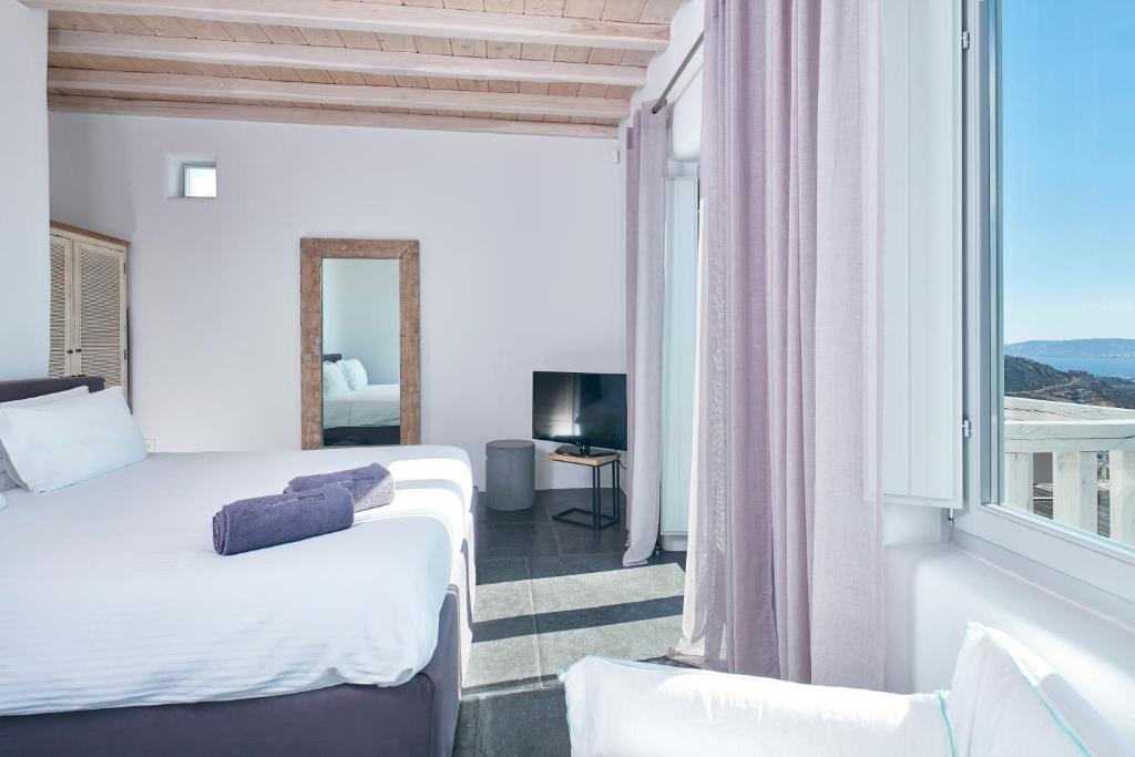 Łóżko lub łóżka w pokoju w obiekcie Ammos Villas