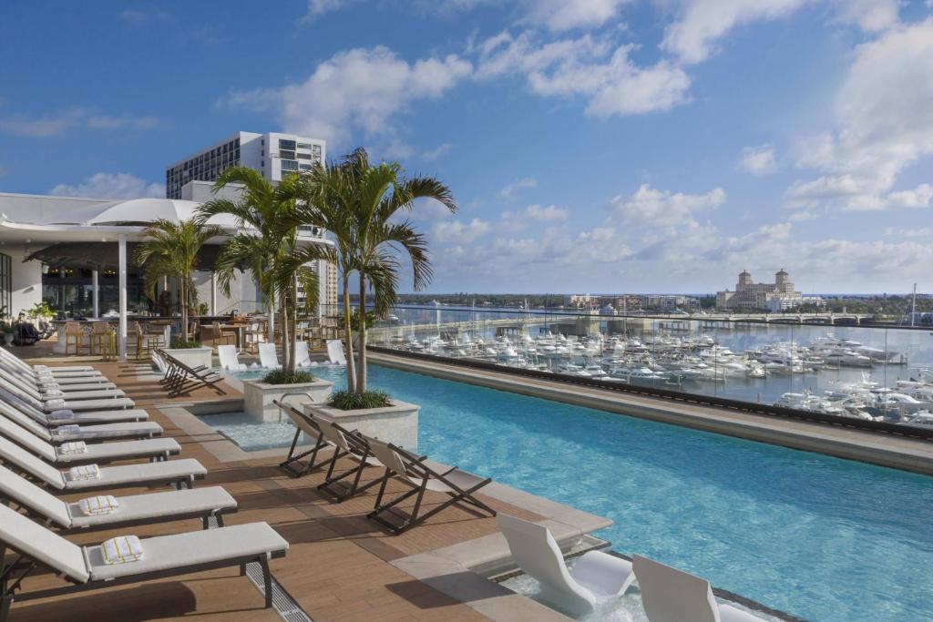 a pool on the roof of a building with boats at The Ben, Autograph Collection in West Palm Beach