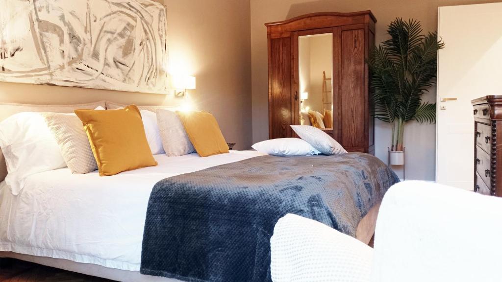 a bedroom with two beds and a mirror at QuickHome - Le due Palme in Biella