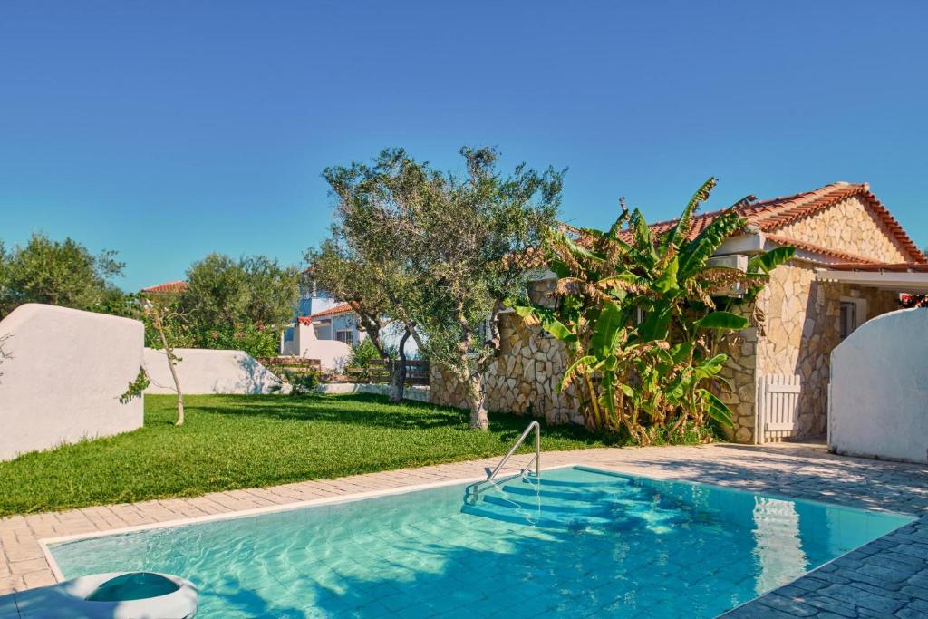 a swimming pool in the backyard of a house at Villa Hera Periyali in Vasilikos