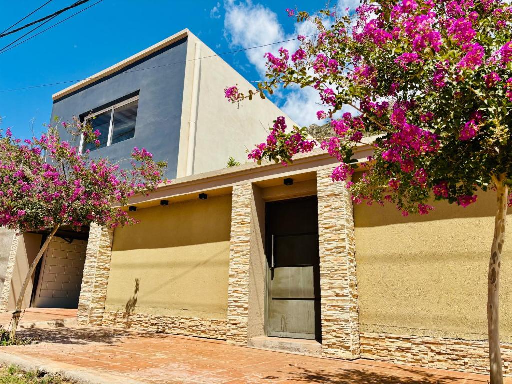 a house with pink flowers in front of it at El Nidito Casa in Chilecito