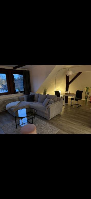 a living room with a couch and a table at Ferienwohnung am Bürgerpark in Bremerhaven